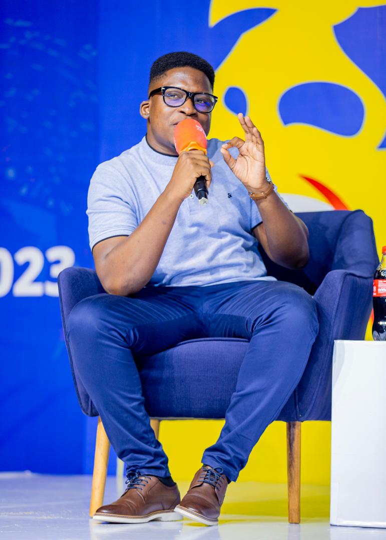 On the mic during a 2023 conference panel